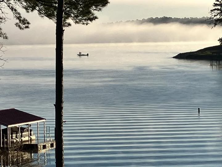 A boat is in the water near a dock.